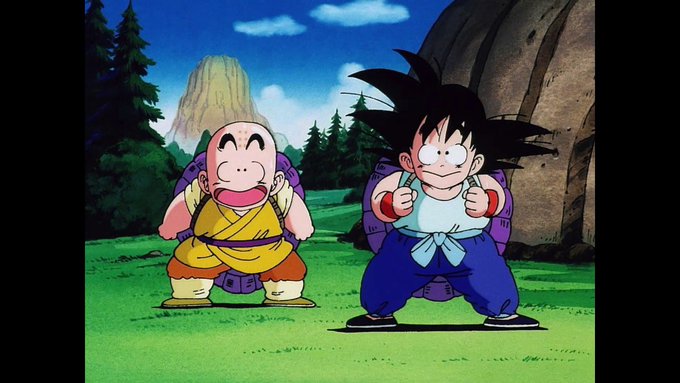 The image features two cartoon characters, one wearing a yellow outfit with a backpack and another dressed in blue with a backpack as well. They are standing next to each other against a backdrop of trees and mountains. The caption for this image reads "$GOKU".