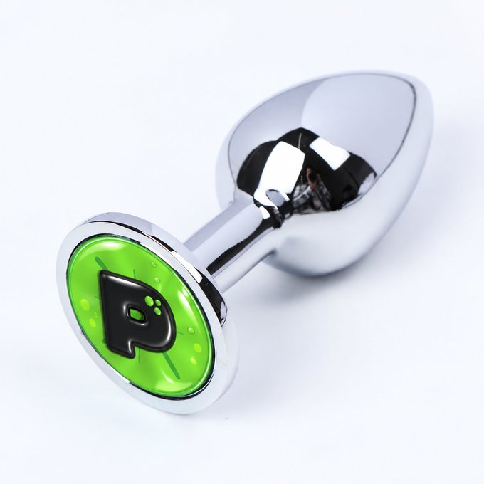 A chrome body jewelry piece (barbell) featuring a green inlay with a black letter 'P' or play symbol.