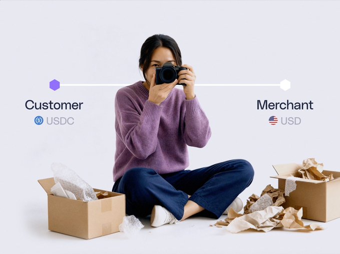 A promotional graphic showing a woman taking a photo while sitting among packing materials, with 'Customer USDC' and 'Merchant USD' labels connected by a line, representing a payment flow.