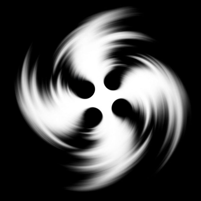 A blurry, black-and-white image of a swirling vortex or spiral with four dark, circular spots arranged in a diamond pattern in the center against a black background.