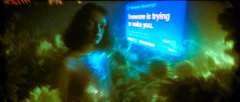A dark, atmospheric scene of a woman with glowing blue lights and text that reads 'Heaven is trying to take you.'