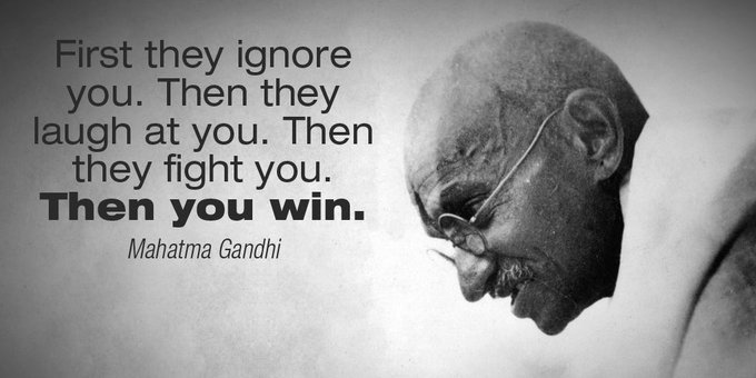 A black and white profile image of Mahatma Gandhi next to the text 'First they ignore you. Then they laugh at you. Then they fight you. Then you win.'