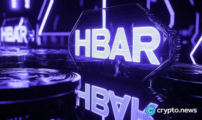 A stylized 3D rendering of a glowing purple "HBAR" cryptocurrency token with the "crypto.news" logo in the bottom right corner.