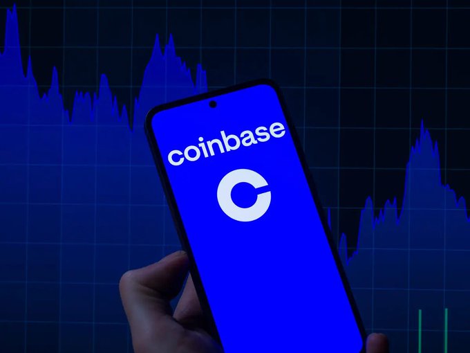 A hand holds a smartphone displaying the Coinbase logo against a dark background featuring a blue stock chart, illustrating the post's poll asking users to vote on which memecoin Coinbase should list next, with options including $MEME, Wiki Cat, $LUNC, Stonk, $BABYDOGE, $CASHCAT, $PONS, and $DOG.