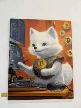An illustration of a white cat wearing a Bitcoin logo necklace, sitting at a computer desk with floating Bitcoin coins in the background.