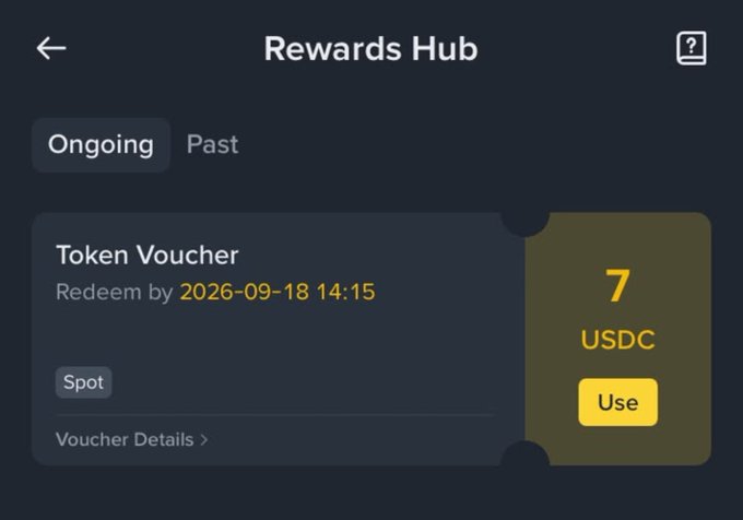 A 'Rewards Hub' screen showing a Token Voucher worth 7 USDC redeemable by 2026-09-18 14:15 for Spot trading.