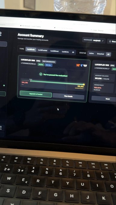 A laptop screen displaying a LucidPlex account summary showing evaluation status with a balance of $61,382, partially visible keyboard in the foreground.