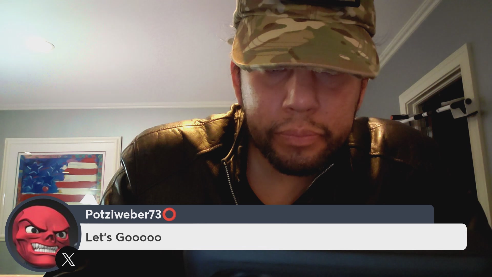 The image features a man wearing a camo hat, sitting at a desk with his laptop open in front of him. The caption for the image reads "MARATHON STREAM! @veve_official PARTNERS WITH EVERYONE! @telegram @roblox $OMI". This suggests that the man is likely participating in an online gaming event or discussion, possibly related to the Marvel Cinematic Universe (MCU) series. The presence of a red mask on the desk adds a touch of humor and intrigue to the scene.