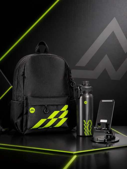 A black backpack with neon green "MA" branding, a matching insulated water bottle, and a phone stand are displayed on a dark surface with green accent lighting, representing the contents of the MGBX perimeter gift box giveaway prize set of 5.