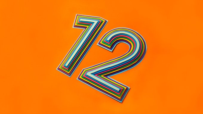 A colorful, multi-layered retro-styled number "12" centered on a bright orange background.