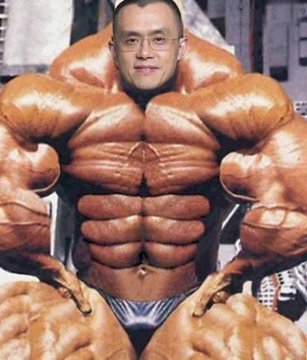 The image shows a bodybuilder with extraordinarily exaggerated, cartoonishly oversized muscles performing a front lat spread pose, wearing small posing trunks. The accompanying post promotes a "$15 giveaway" requiring engagement (quoting and tagging @cz_binance), but the image appears unrelated to the giveaway text, possibly used misleadingly to attract clicks.