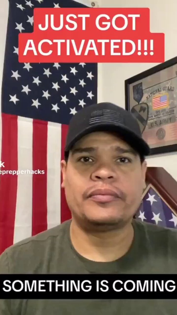 The image features a man wearing a hat standing next to an American flag that displays "Just Got Activated!" written in red above him, with the caption "Something big is coming!". The focus of the image seems to be on the man's interaction or enthusiasm for his newly activated account, possibly related to a new online service or product.