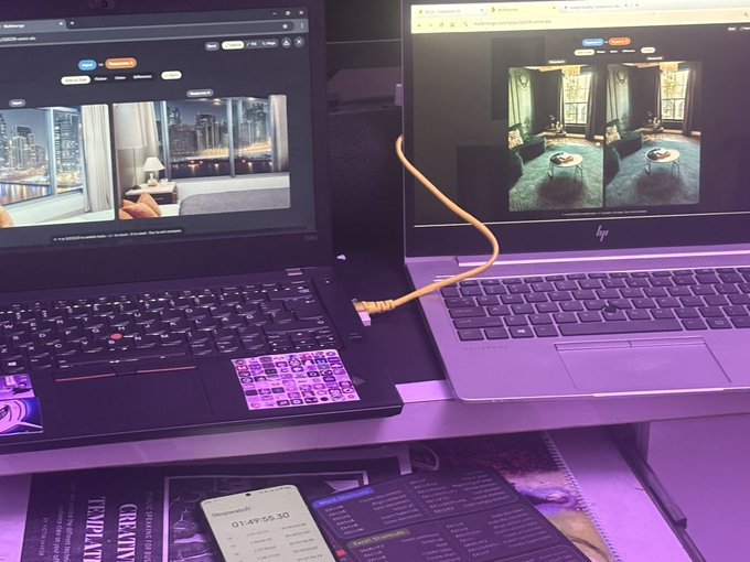 A desk setup with a Lenovo laptop on the left and an HP laptop on the right, both displaying interior design images, connected by a yellow ethernet cable, with a smartphone showing '01:47:55.30' timer below.