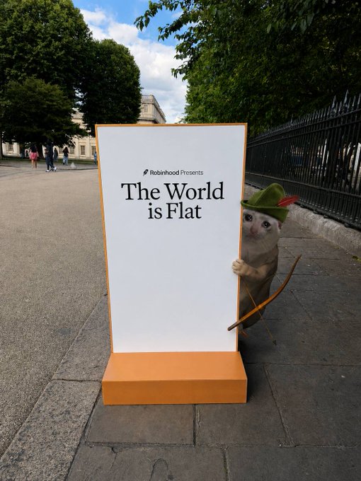 A Robinhood Presents sign reads "The World is Flat" on a sidewalk, with a cat wearing a green Robinhood-style hat peeking out from behind it. The whimsical image humorously ties into the post by playing on Robinhood's branding while suggesting the marketing messages are becoming inescapable.