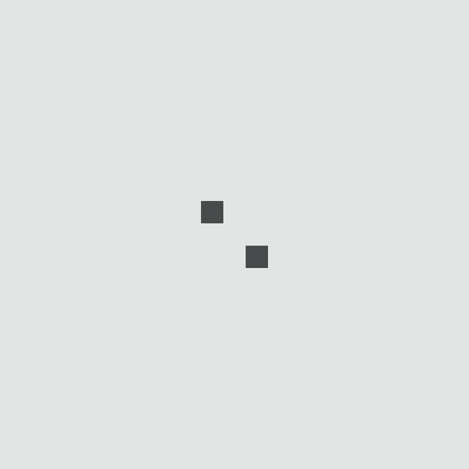 A minimalist image showing two small dark gray squares arranged diagonally on a very light blue background.