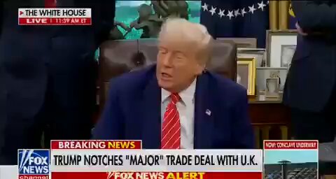 The image shows a news segment featuring former President Donald Trump sitting at a desk with his hands on his lap. The news anchor is reporting that the Federal Reserve has been given the task of standing down the U.S. dollar, which could potentially lead to the creation of a new digital currency called Ripple. This digital currency is being referred to as "green" by some viewers and is described as a multi-trillion-dollar market with token positioning at its center. The news segment also includes text about Trump's recent speech on Twitter.