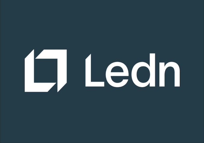 The image features a logo for Ledn, which is a company that provides Bitcoin-backed loans. The logo consists of a square with an arrow pointing upwards inside it, accompanied by the word "ledn" written below it. The background color of the logo is blue, and there are two white letters on the bottom right corner of the image.