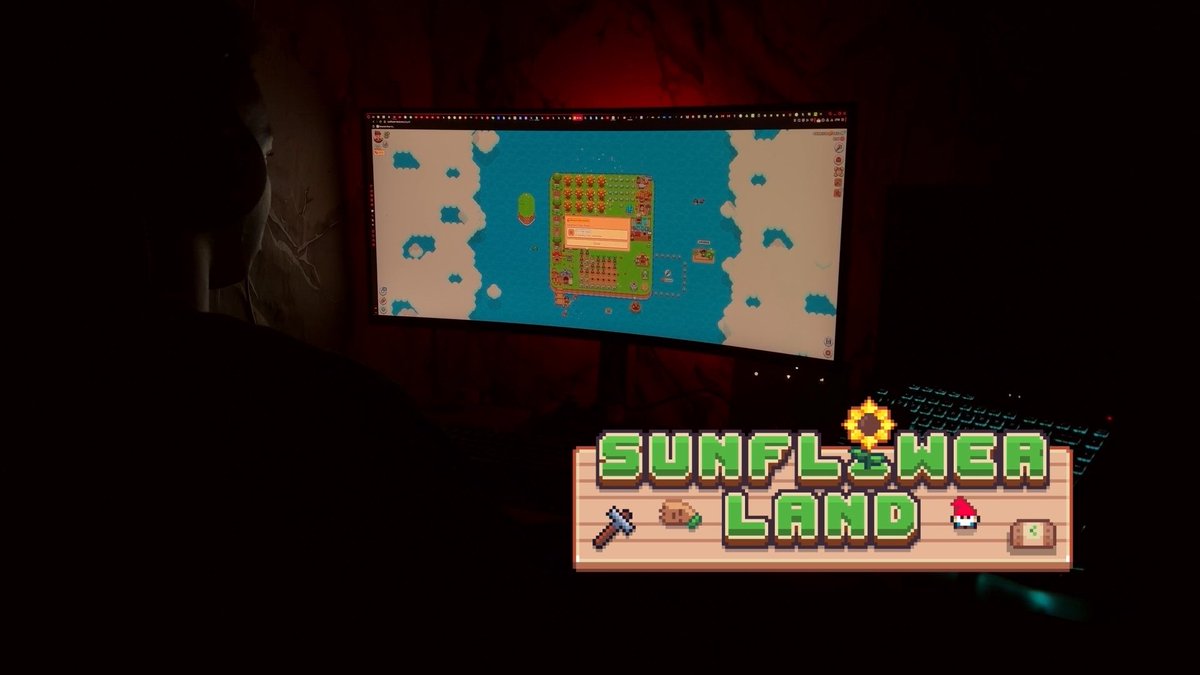A silhouetted person plays a pixel-art farming game on a monitor, overlaid with a 'SUNFLOWER LAND' logo featuring a pickaxe, hoe, mushroom, and seed packet.