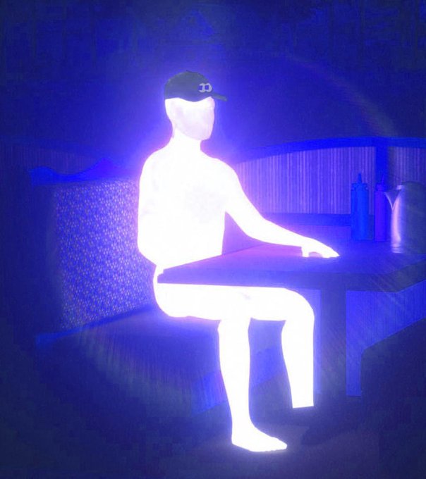 An inverted/color-inverted photo showing a silhouetted figure in a cap sitting at a table, rendered in blue and white tones.