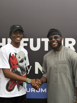 Two men smile and shake hands in front of a 'HIGH FUTUR Ly NOV URUM' branded event backdrop.