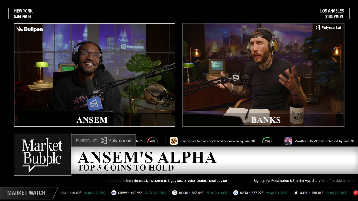 The image shows two men sitting behind microphones at a news broadcast station. They are talking about the stock market and the best way to invest money. The first man is wearing glasses, while the second one has a beard. Both of them have their hands on the microphone, suggesting they are discussing important financial topics or sharing insights with viewers.