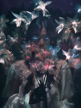 A surreal, dark fantasy portrait of a pale figure with glowing blue eyes surrounded by white lily-like flowers and glowing pink flora.