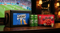 A product photograph of Guinness beer cans and a red pomegranate box on a bar counter next to a small tablet screen showing a football match labeled 'Gateaway World Cup'.
