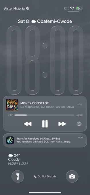 An iPhone lock screen on Airtel Nigeria showing the time 08:00, playing the song 'MONEY CONSTANT' by DJ Maphorisa, DJ Tunez, Wizkid, and Mavo, along with weather details for Obafemi-Owode.