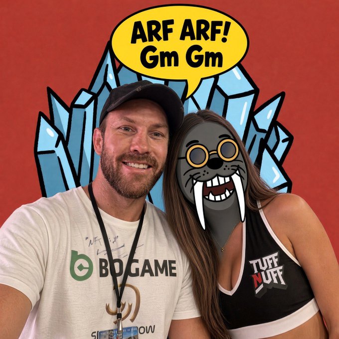 A man wearing a "BDGAME" shirt and a woman in a "TUFF NUFF" top pose together with a cartoon walrus filter over the woman's face and a speech bubble reading "ARF ARF! Gm Gm" against a graffiti background, playfully responding to the post's request for a "GM" or "ARF ARF" greeting tagged to @sealonxrp.