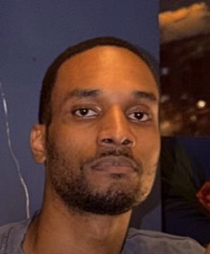 A serious-looking man with a beard stares directly at the camera, likely a stock or article image accompanying news about the FBI arrest of a hacker who allegedly hid crypto-stealing malware within Steam video games to steal passwords, data, and drain victims' cryptocurrency wallets.