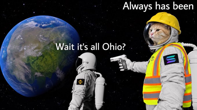 A variation of the astronaut meme featuring a cat in a yellow hard hat and reflective vest pointing a gun at an astronaut viewing Earth, with text reading "Always has been" and "Wait it's all Ohio?"