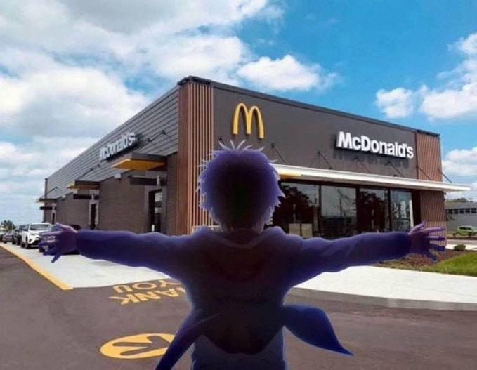 A silhouetted figure with arms outstretched triumphantly stands before a McDonald's restaurant, with the golden arches logo and "McDonald's" signage clearly visible in the background. The image humorously symbolizes the celebratory feeling of "being ready" after accumulating a small position in a stock, playfully framing the investor as a triumphant hero outside the iconic fast-food brand.
