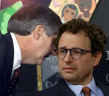 Two men in suits are shown in close conversation, with one whispering into the other's ear during what appears to be a conference or event setting. The image symbolizes the quiet, behind-the-scenes business discussions referenced in the post about major tech companies like Microsoft and Meta significantly cutting their spending and usage of Anthropic's Claude AI.