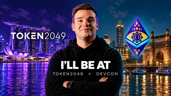 A promotional graphic features Vitalik Buterin with the text "TOKEN2049 I'LL BE AT TOKEN2049 + DEVCON" set against a night skyline of Singapore and the Ethereum logo.