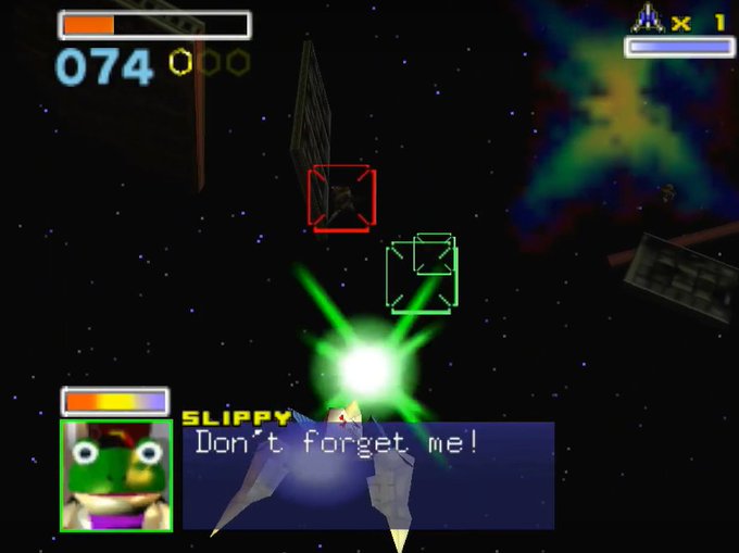 A screenshot of a Star Fox video game showing Slippy saying "Don't forget me!" with a green laser blast in space.