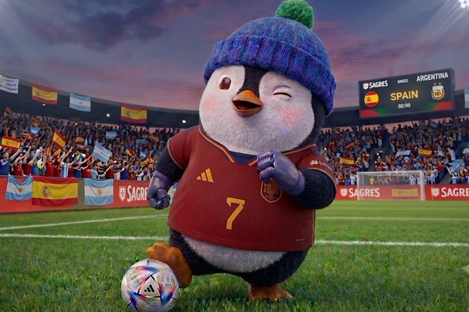 An animated penguin mascot wearing a blue knit beanie and a red jersey with the number 7 kicks a soccer ball on a stadium field, with the scoreboard reading "SPAIN 00:00" against Argentina. The image ties into the World Cup final theme by playfully suggesting that trading on MEXC is as exciting as scoring a goal in the championship match.