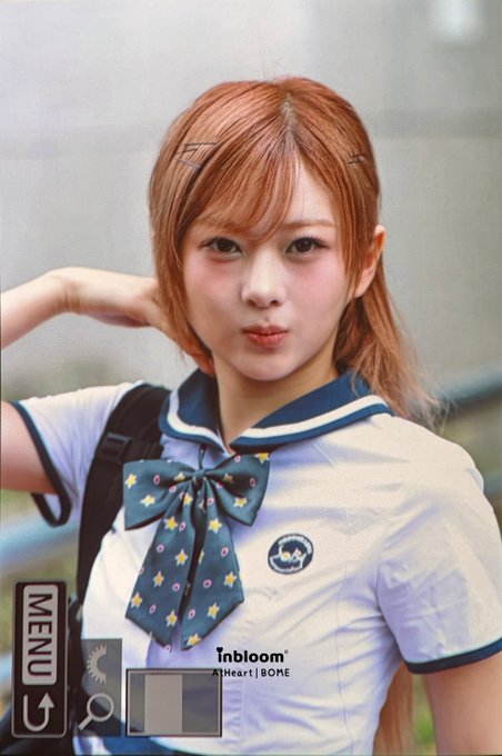 A photo of a young woman with reddish-blonde hair wearing a sailor-style school uniform with a star-patterned bow, with a "MENU" overlay and "inbloom | AtHeart | SOME" text at the bottom.
