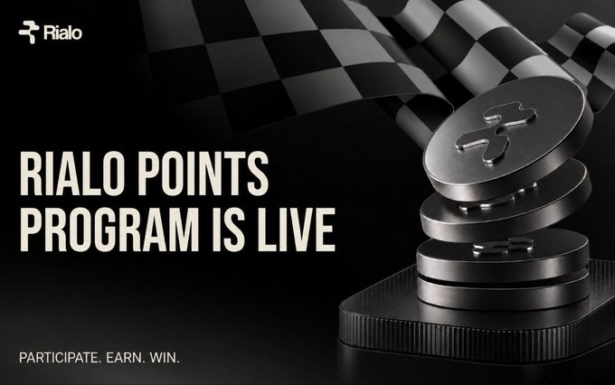 A promotional graphic announces 'RIALD POINTS PROGRAM IS LIVE' with the tagline 'PARTICIPATE. EARN. WIN.' featuring the Rialo logo and stacked metallic coins with a checkered flag.