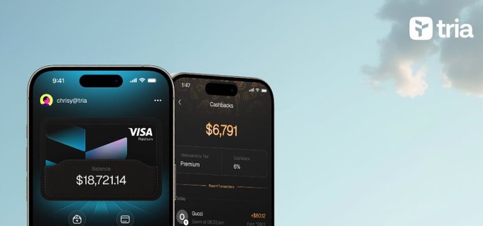 Two smartphones displayed against a blue sky background with clouds, showing the 'tria' fintech app interface with Visa Platinum card details, including a balance of $18,721.14 and a cashback section showing $6,791, with the 'tria' logo in the top right corner.