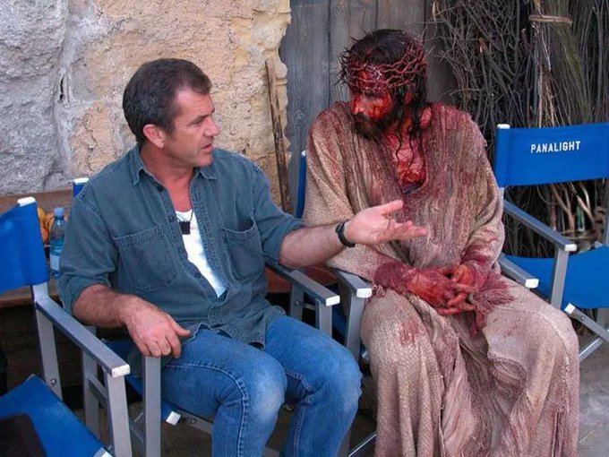 Mel Gibson is seen speaking with an actor portraying Jesus Christ, who is heavily bloodied and wearing a crown of thorns, likely on the set of "The Passion of the Christ." This image highlights the intense depiction of suffering in the film, subtly relating to the post's implication that "Bitcoiners were so lucky" by perhaps referencing the extreme hardships and sacrifices depicted, contrasting them with perceived luck in other contexts.
