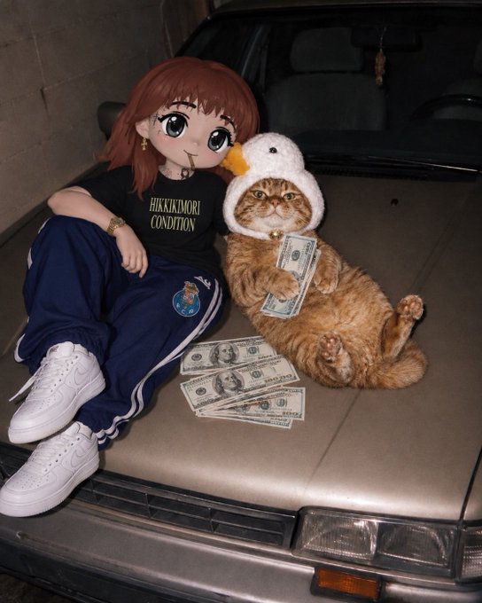 An anime-style character with red hair sits on a car hood next to an orange cat wearing a duck hood, with both posing with stacks of dollar bills.
