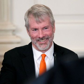 Michael Saylor, recognizable by his signature gray beard and orange tie, smiles during an interview setting, visually reinforcing the accompanying post where he argues that the rejection of the CLARITY Act represents a "positive inflection point" for the crypto industry as digital assets pursue favorable regulation from agencies like the SEC and CFTC.