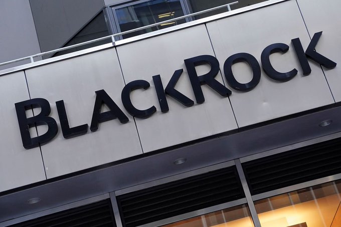 A photograph of the exterior of a building featuring a large sign with the word 'BLACKROCK' in bold black letters against a white background.