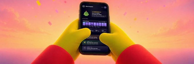 The image shows gloved yellow hands holding a smartphone displaying the "Sleep Enigma" screen of the Sleepagotchi app, with the caption noting the user opened Sleepagotchi while half asleep and saw no new Dingo road map progress after staying up too late.
