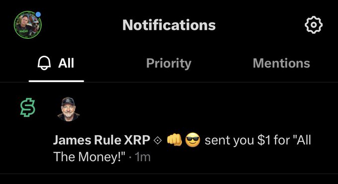A screenshot of X (Twitter) notifications showing James Rule XRP sent a $1 tip with the message "All The Money!" along with fist bump and sunglasses emojis, received 1 minute prior. The caption celebrates this first X Dollar tip from the "All The Money" community.