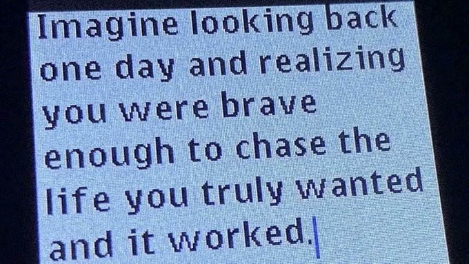 A motivational quote displayed on a screen reading: 'Imagine looking back one day and realizing you were brave enough to chase the life you truly wanted and it worked.'