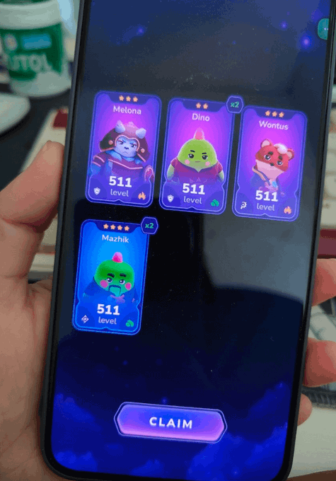 A smartphone screen displaying a mobile game with four character cards (Melona, Dino, Wontus, Mazhik), each at level 511, above a 'CLAIM' button.