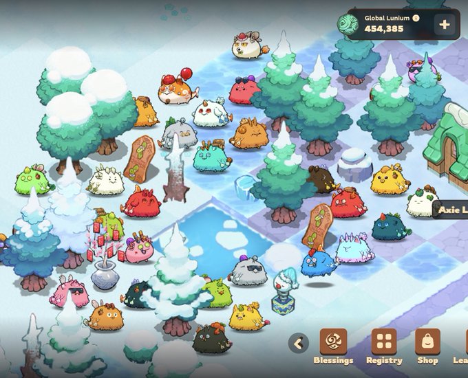 A screenshot from the mobile game Axie Infinity showing a winter-themed gameplay area with various colorful Axie creatures, snow-covered pine trees, a frozen pond, and the interface showing "Global Lunium 454,355" at the top.