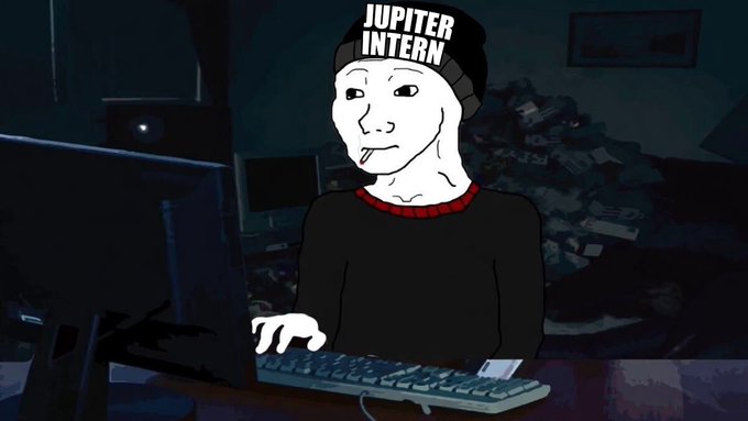 Meme illustration of a Wojak-style figure wearing a 'JUPITER INTERN' beanie, sitting at a computer in a dark room and typing on a keyboard.