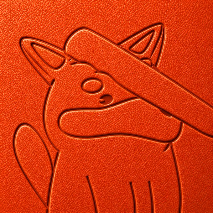 urn of orange leather with a cat illustration on the front, featuring two ears and eyes, holding an object over its head.